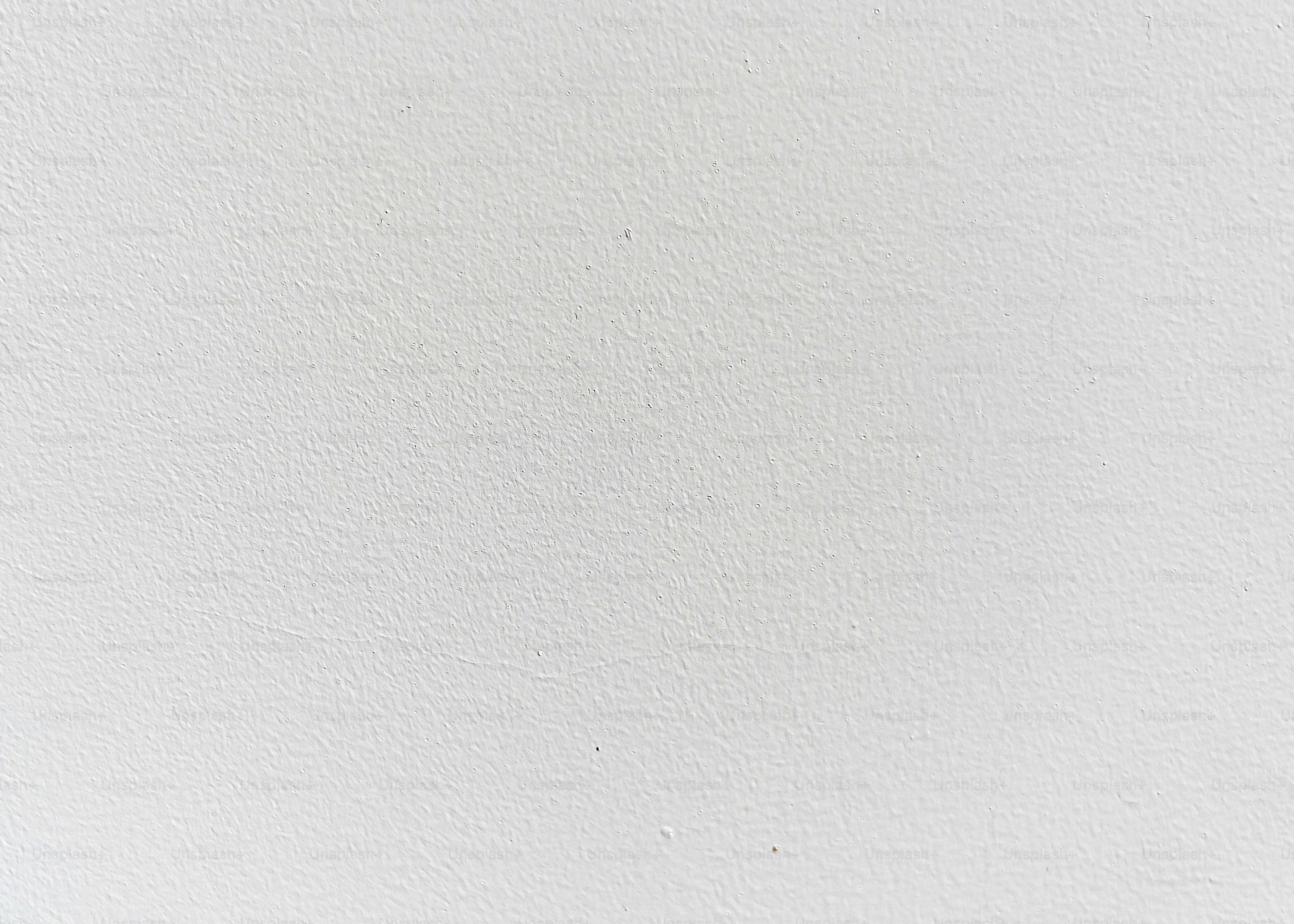 a black and white photo of a white wall